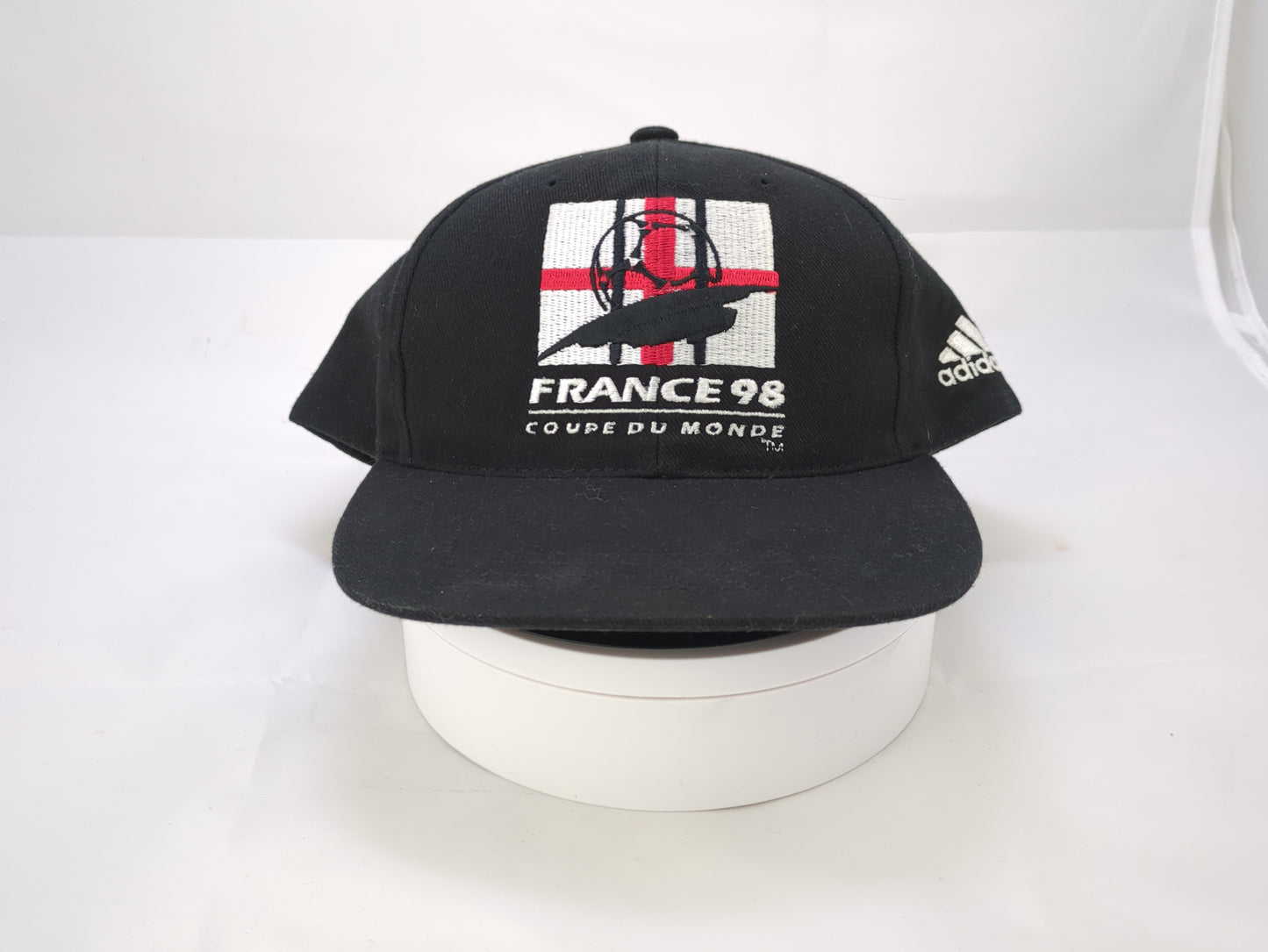 Black face mask with a logo on a white background